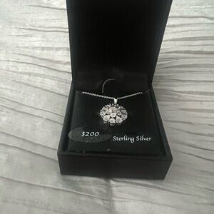 Diamond flower bursts set in a sterling silver necklace.